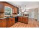Well-appointed kitchen with wooden cabinetry, granite countertops, and hardwood floors at 10158 E Fair Cir, Englewood, CO 80111