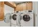 Functional laundry room featuring modern front-load washer and dryer units at 10158 E Fair Cir, Englewood, CO 80111