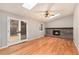 Elegant living room featuring a brick fireplace and doors leading to the outdoors at 10158 E Fair Cir, Englewood, CO 80111