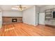 Cozy living room with a brick fireplace, hardwood floors, and natural light from skylights at 10158 E Fair Cir, Englewood, CO 80111