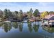 Scenic pond surrounded by lush trees and beautiful houses at 10158 E Fair Cir, Englewood, CO 80111