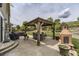 Outdoor living space with covered gazebo, dining table, fireplace, and bbq area at 11895 Hitching Post Ct, Parker, CO 80134