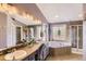 Spa-like bathroom featuring a soaking tub, glass-enclosed shower, double vanity, and great natural light at 11895 Hitching Post Ct, Parker, CO 80134