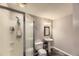 Simple bathroom featuring stand-up shower, pedestal sink, and dark floors at 11895 Hitching Post Ct, Parker, CO 80134