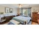 Inviting bedroom showcasing hardwood floors, neutral paint, and a stylish black iron bed at 11895 Hitching Post Ct, Parker, CO 80134