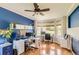 Bright home office with hardwood floors, multiple workstations, and a large window view at 11895 Hitching Post Ct, Parker, CO 80134