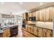 Modern kitchen featuring wooden cabinets, granite countertops, and stainless steel appliances at 11895 Hitching Post Ct, Parker, CO 80134