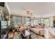 Expansive living room showcases hardwood floors, neutral decor, and seamlessly connects to the dining area at 11895 Hitching Post Ct, Parker, CO 80134