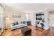 Comfortable living room featuring hardwood floors, a cozy sofa with stylish pillows, and a unique fish tank at 11895 Hitching Post Ct, Parker, CO 80134