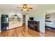 Cozy living area featuring hardwood floors, wet bar, ceiling fan, and electric fireplace at 11895 Hitching Post Ct, Parker, CO 80134