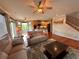 Cozy living room featuring hardwood floors, a comfortable sofa, and a staircase at 11895 Hitching Post Ct, Parker, CO 80134