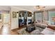 Cozy living room featuring a fireplace, built-in shelving, neutral decor and a decorative rug at 11895 Hitching Post Ct, Parker, CO 80134