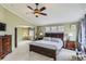Spacious main bedroom with high ceilings, decorative ceiling fan, and a separate sitting area at 11895 Hitching Post Ct, Parker, CO 80134