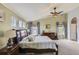 Bright main bedroom showcasing an ensuite sitting area, a large bed, and ample natural light at 11895 Hitching Post Ct, Parker, CO 80134