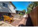 Landscaped backyard with hot tub, raised garden beds, and flagstone path at 9238 W Virginia Cir, Lakewood, CO 80226