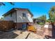 Backyard oasis with hot tub, raised garden beds, and flagstone path at 9238 W Virginia Cir, Lakewood, CO 80226