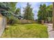 Large, fenced backyard with a well-maintained lawn and a wooden deck, perfect for outdoor entertaining at 7166 Newhall Dr, Highlands Ranch, CO 80130