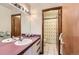 Hall bathroom with a vintage sink and a shower separated by a curtain at 7166 Newhall Dr, Highlands Ranch, CO 80130