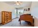Comfortable bedroom featuring light-colored carpet, a ceiling fan, and a dresser by two windows at 7166 Newhall Dr, Highlands Ranch, CO 80130