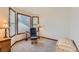 Cozy sitting area with a comfortable chair, side table, and natural light from the windows at 7166 Newhall Dr, Highlands Ranch, CO 80130