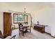 Cozy dining room featuring a large window and traditional furniture, perfect for Gathering meals and entertaining at 7166 Newhall Dr, Highlands Ranch, CO 80130