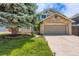 Charming home with a stone facade, attached garage, and a well-maintained front yard with mature tree at 7166 Newhall Dr, Highlands Ranch, CO 80130