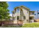 Exterior view of the home featuring a spacious wooden deck, a bay window, and well-kept lawn at 7166 Newhall Dr, Highlands Ranch, CO 80130