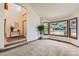 Bright living room with large windows, neutral carpet, and an open entry way, creating a seamless flow at 7166 Newhall Dr, Highlands Ranch, CO 80130
