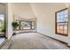 Spacious living room with bay windows that offer plenty of natural light and soft carpeting for added comfort at 7166 Newhall Dr, Highlands Ranch, CO 80130