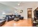 Cozy living room with a large gray sectional sofa, hardwood floors, and recessed lighting at 7166 Newhall Dr, Highlands Ranch, CO 80130