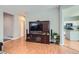 Living room featuring hardwood floors, a TV console with speakers, and access to other rooms at 7166 Newhall Dr, Highlands Ranch, CO 80130
