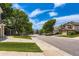 A neighborhood street view showcasing tree-lined sidewalks and well-maintained homes with manicured lawns at 7166 Newhall Dr, Highlands Ranch, CO 80130