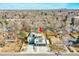 An aerial view highlights a modern home with multi-level decks, a well-manicured yard, and a spacious driveway at 3910 Reed St, Wheat Ridge, CO 80033