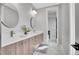 Well-lit bathroom featuring a double vanity, sleek mirrors, and modern fixtures at 3910 Reed St, Wheat Ridge, CO 80033