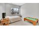 Neutral bedroom features a comfy bed, a window with a view, and a table with a playset at 3910 Reed St, Wheat Ridge, CO 80033