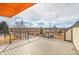 An outdoor deck with a view of the surrounding neighborhood and beautiful blue skies at 3910 Reed St, Wheat Ridge, CO 80033