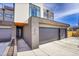 Modern home showcasing a three-car garage, brick accents, and contemporary design in a desirable neighborhood at 3910 Reed St, Wheat Ridge, CO 80033