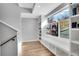 Well-lit hallway with built-in shelves, a window seat, and hardwood floors at 3910 Reed St, Wheat Ridge, CO 80033