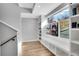 Bright hallway with built-in shelving and bench, illuminated by a large window at 3910 Reed St, Wheat Ridge, CO 80033