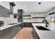 Modern kitchen with a spacious island, custom black cabinets, and stylish pendant lighting at 3910 Reed St, Wheat Ridge, CO 80033