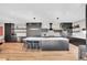 Modern kitchen with sleek black cabinets, a large island, and stainless-steel appliances at 3910 Reed St, Wheat Ridge, CO 80033