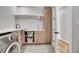 Well-organized laundry room with a modern washer, storage cabinets, and ample counter space at 3910 Reed St, Wheat Ridge, CO 80033