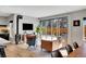 Modern living room features a cozy fireplace, stylish furniture, and large sliding doors to the patio at 3910 Reed St, Wheat Ridge, CO 80033