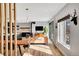 Well-lit living room featuring hardwood floors, fireplace, and sliding glass doors to the backyard at 3910 Reed St, Wheat Ridge, CO 80033