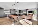 Bright and airy living room with modern kitchen, dining table, and stylish lighting fixtures at 3910 Reed St, Wheat Ridge, CO 80033