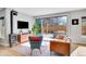 Bright living room featuring modern furniture, sleek fireplace, and sliding glass doors to the outdoor area at 3910 Reed St, Wheat Ridge, CO 80033