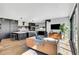 Open concept living area with modern kitchen, fireplace, leather sofa, and expansive windows at 3910 Reed St, Wheat Ridge, CO 80033