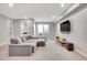 Comfortable living room boasts a plush sectional, large window, and wall-mounted television at 3910 Reed St, Wheat Ridge, CO 80033