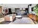 Open living and dining space with modern decor, hardwood floors, and dark cabinetry at 3910 Reed St, Wheat Ridge, CO 80033