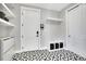 Neat mud room featuring stylish tile floor, storage shelves, and convenient coat hooks at 3910 Reed St, Wheat Ridge, CO 80033